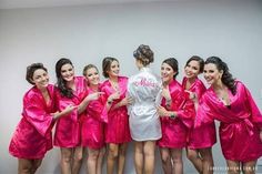 a group of women in pink robes standing next to each other