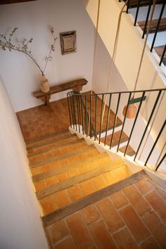 a stair case next to a wooden bench