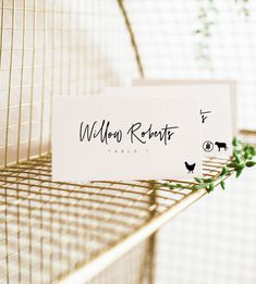 two place cards sitting on top of a wire rack