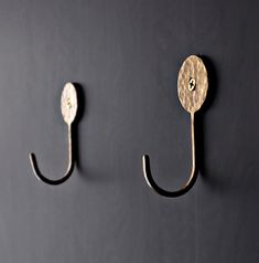 two hooks on the wall are holding something