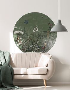 a living room scene with focus on the sofa and wall mural behind it, as well as a chair