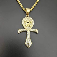 Step into the allure of ancient Egypt with our Iced Out Ankh Cross Stainless Steel Necklace. Meticulously crafted, this necklace features a dazzling Ankh Cross adorned with sparkling details, adding a touch of glamour to the timeless symbol of eternal life. Elevate your look with this statement piece, embodying the rich symbolism of ancient Egypt." Metals Type: Stainless Steel Material: Rhinestone Chain Width: 5mm We ship worldwide to 185 countries! Please allow 1-2 business weeks for your order Cross Necklace Mens, Eye Of Horus Necklace, Cosmic Jewelry, Egypt Jewelry, The Eye Of Horus, Egyptian Ankh, Ankh Necklace, Ankh Cross, Necklace Mens