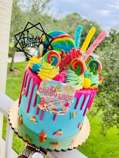 a birthday cake decorated with candy and lollipops on the top of it