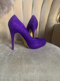 Royal purple covers the entire top portion of the heels while the underside is covered in an ultra fine yellow glitter. These heels can be made in any color combo desired. If you would like another color combination please leave your color choices at checkout otherwise your pair will be created in the colors shown. Purple Platform Heels For Party, Purple High Heel Party Heels, Glamorous Purple High Heels, Glamorous Purple Closed Toe Heels, Purple Glitter High Heels, Yellow High Heels, Heels Purple, Womens Costume, Glitter High Heels