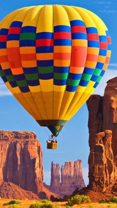 a hot air balloon flying over the desert