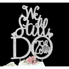 we still do cake topper with pink rose on table next to white box and black background