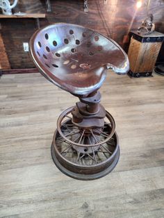 an old metal chair sitting on top of a wooden floor