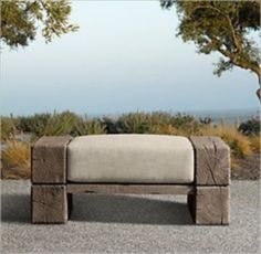 a wooden bench sitting on top of a gravel field