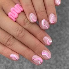 two hands with pink and white nail designs