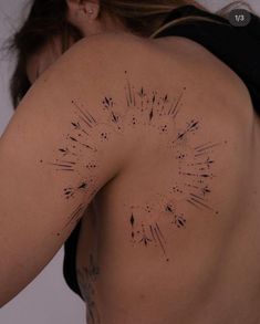 the back of a woman's body with black ink sprinkles on it