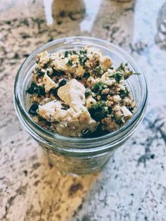 a glass jar filled with food sitting on top of a counter