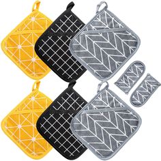 four oven mitts and one pot holder in yellow, black, grey and white