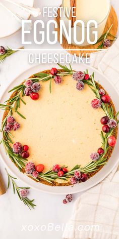 an eggnog cheesecake with cranberries and rosemary on top