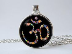 Om symbol necklace Om jewelry Om sign pendant Hindu symbol Yoga necklace Boho Hippie Zen Om necklace Yoga Gift for her Spiritual necklaceIn the options you can choose: Style, Metal color and Engraving.Jewelry is made up of metal base, chain or key ring, glass lens and image.Pendant size: 1 inch (2.5cm).If you chose in the option "+Engraving", please write the text, words or date for engraving. This text will be engraved on the back of the product.I will place the text in one or more lines, depen Symbolic Multicolor Jewelry For Gift, Symbolic Multicolor Necklaces For Gifts, Symbolic Multicolor Necklace For Gift, Symbolic Necklaces For Festivals, Hindu Symbol, Engraving Jewelry, Om Jewelry, Om Sign, Hindu Symbols