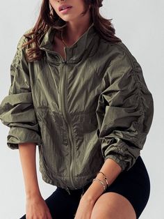 "NO REFUNDS-please check sizing  Small (2/4), Medium (6/8), Large (10/12) Activewear that is stylish and practical with ruched sleeves - lightweight windbreaker jacket. Crafted from 100% nylon, this jacket offers durability and water-resistant properties, making it perfect for unpredictable weather conditions.  This jacket packs down small into for easy carrying and travel. The high neck design provides added protection, while the zip-up front allows for easy on and off. The ruched sleeves add a trendy touch, giving the jacket a unique and fashionable look. With its functional front pockets, you can conveniently store your essentials while on the go. Whether you're heading out for a hike or running errands, this windbreaker jacket is a versatile and must-have addition to your wardrobe. Mod Green Long-sleeve Outerwear With Drawstring, Green Long Sleeve Outerwear With Drawstring, Spring Stretch Outerwear For Outdoor Activities, Nylon Track Jacket With Elastic Cuffs, Spring Khaki Outdoor Track Jacket, Green Sporty Outerwear With Drawstring, Sporty Green Outerwear With Drawstring, Winter Long Sleeve Track Jacket With Drawstring, Casual Fall Windbreaker With Elastic Cuffs