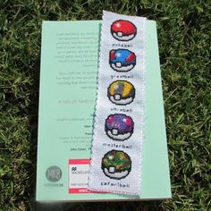 the bookmark is decorated with pictures of different types of pokemons on it's cover