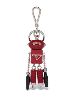 a red robot shaped keychain hanging from a chain