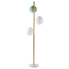 three light floor lamp with marble base and two glass balls on the top, in gold