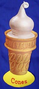 an ice cream cone with the word dairy queen on it next to a measuring ruler