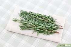 fresh herbs are laid out on a cloth