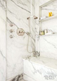 a bathroom with white marble walls and floor