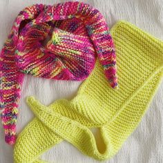 two knitted hats and one crochet scarf are laying on a white surface