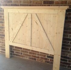 a wooden headboard made out of pallet wood with a barn door on top