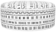 a white and black round poufce with an intricate design on the top,