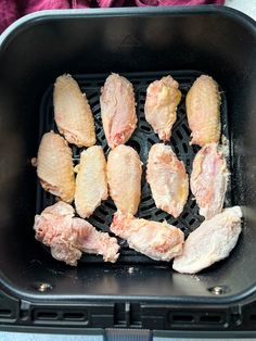 chicken is being cooked in an air fryer