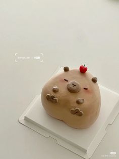 a cake shaped like a rock on top of a white plate with red cherries