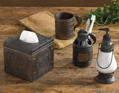 three different types of bathroom items on a wooden table with towels and soap dispensers