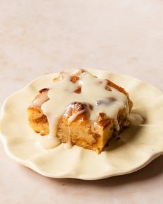 a piece of cake on a plate with icing drizzled over it