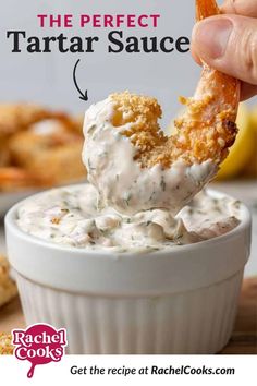 the perfect tartar sauce recipe is in a small white bowl with a hand dipping it