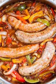 sausages and peppers are cooked in a pot