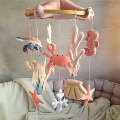 a baby crib mobile with sea animals and seashells