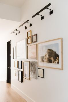 a white wall with pictures hanging on it's side and the words shop below