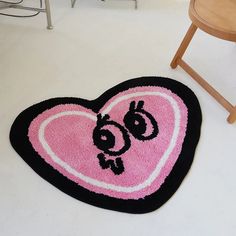 a heart shaped rug on the floor next to a chair