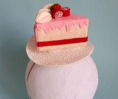 a piece of cake sitting on top of a white head mannequin's head