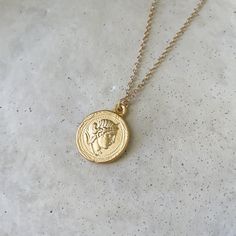 "A beautiful round Artemis and temple of Artemis double sided pendant in a rich matte finish gold. The relief on this pendant is gorgeous. The chain is a smooth cable in a 24k gold plated matte finish. Wear alone or layer with our other beautiful Greek pieces!  Size: 18 or 20\" Chain 25mm pendant Specs: Matte Finish pendant and chain 24k gold plated brass 24K gold plated chain Easy to use Clasp The richer color is due to the higher gold content in the plating. Wear and Care: Do not wear in chlorinated water. Wipe clean with a jewelry polishing cloth. Store your jewelry with care. This chain can tangle."