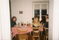 a group of people sitting around a table