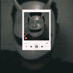 a person wearing a white mask and headphones with an mp3 player in front of them