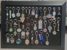 a shadow box with key chains and other items in it