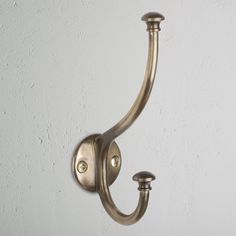 a wall mounted light with two lights on it's side and a white wall in the background