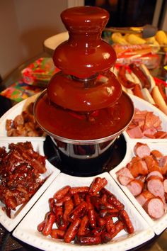 an assortment of food is displayed on a platter, including hot dogs and sausages