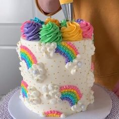 there is a cake decorated with rainbows and icing