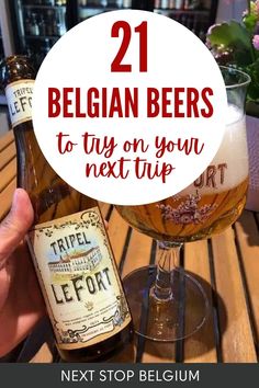 a person holding up a beer bottle with the words 21 belgan beers to try on your next trip