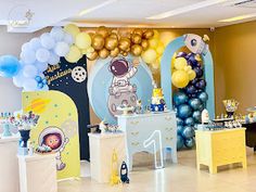 an astronaut themed birthday party with balloons and decorations