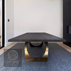 a black table sitting on top of a carpeted floor next to a white wall