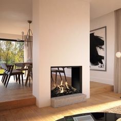 a living room filled with furniture and a fire place in front of a large window