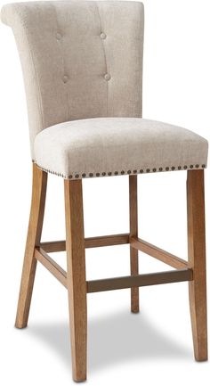 an upholstered chair with wooden legs and buttons on the back, against a white background